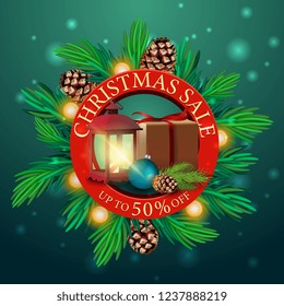 Round discount Christmas banner with Christmas tree branches, garland and gifts with old lamp