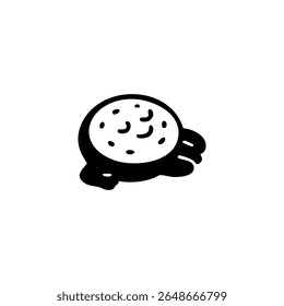 Round food item with small, textured details and dripping sauce