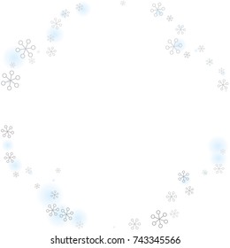 Round frame or border Christmas background with random scatter falling silver snowflakes and blue blurred dots isolated on white.