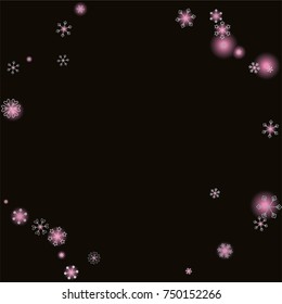 Round frame or border Christmas background with random scatter falling silver snowflakes and pink blurred lights isolated on black