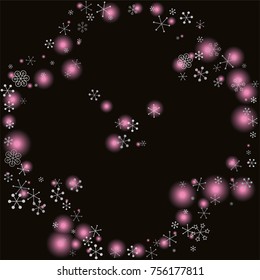 Round frame or border Christmas background with random scatter falling silver snowflakes and pink blurred lights isolated on black