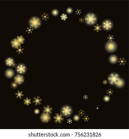 Round frame or border Christmas background with random scatter falling gold snowflakes and yellow blurred lights isolated on black.