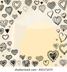 Round frame filled with hand drawn hearts on beige and yellow stains.