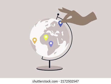 A round Globe on a metal stand with location pin stickers on it, educational and travel concept