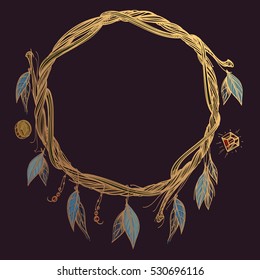 Round golden frame made of branches with feathers and leaves. Decorative element for design work in the boho style. Wreath on a dark background.