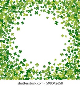 Round green frame, border or background of random scatter clover leaves. Elegant St. Patricks day design for festive banner, greeting card, postcard, flyer. Vector illustration.