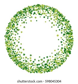 Round green frame, border or background of random scatter clover leaves with tails. Elegant St. Patricks day design for festive banner, greeting card, postcard, flyer. Vector illustration.