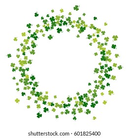 Round green frame, border or background of random scatter clover leaves with tails. Elegant St. Patricks day design for festive banner, greeting card, postcard, flyer. Vector illustration.