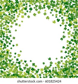 Round green frame, border or background of random scatter clover leaves with tails. Elegant St. Patricks day design for festive banner, greeting card, postcard, flyer. Vector illustration.