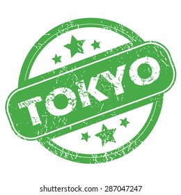 Round green rubber stamp with name Tokyo and stars, isolated on white