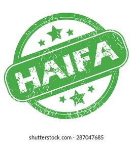 Round green rubber stamp with name Haifa and stars, isolated on white
