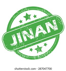 Round green rubber stamp with name Jinan and stars, isolated on white