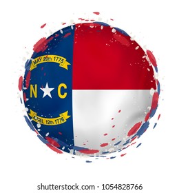 Round grunge flag of North Carolina US state with splashes in flag color. Vector illustration.