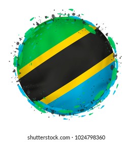 Round grunge flag of Tanzania with splashes in flag color. Vector illustration.