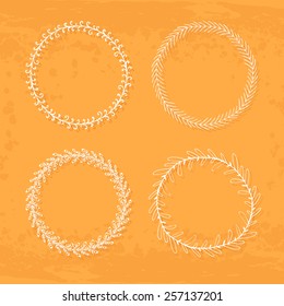 Round handdrawn wreaths on texturized vintage background. Collection of clip art vector bouquets. Romantic wreath with copyspace for your text.  