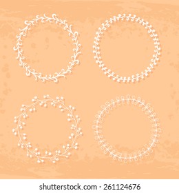 Round handdrawn wreaths on texturized vintage background. Collection of clip art vector bouquets. Romantic wreath with copyspace for your text. 
