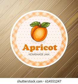 round label, apricot jam on a wooden background
