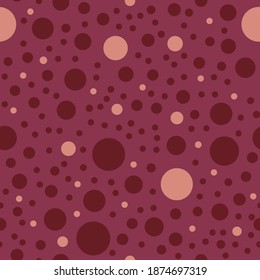 Round light pink and red shapes on  crimson background. Seamless abstract simple pattern. Suitable for wrapping paper, textile.