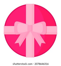 Round pink box of chocolates with bow for Valentine's Day.