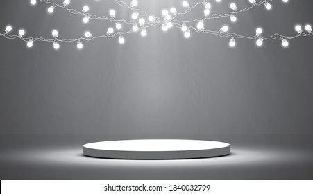 
Round podium, pedestal or platform illuminated by spotlights on a gray background, holiday lanterns.