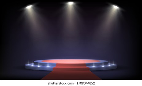 Round stage with steps and spotlights, red carpet on a pedestal