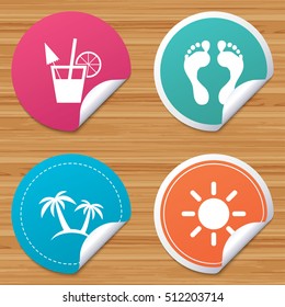 Round stickers or website banners. Beach holidays icons. Cocktail, human footprints and palm trees signs. Summer sun symbol. Circle badges with bended corner. Vector