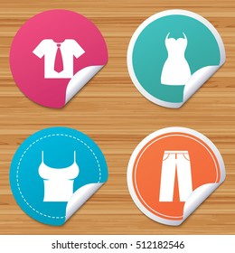 Round stickers or website banners. Clothes icons. T-shirt with business tie and pants signs. Women dress symbol. Circle badges with bended corner. Vector