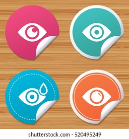 Round stickers or website banners. Eye icons. Water drops in the eye symbols. Red eye effect signs. Circle badges with bended corner. Vector