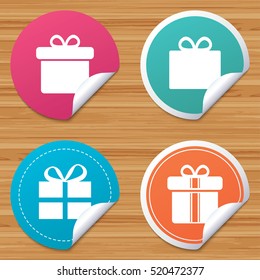 Round stickers or website banners. Gift box sign icons. Present with bow and ribbons sign symbols. Circle badges with bended corner. Vector