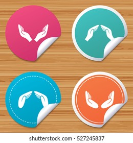 Round stickers or website banners. Hands icons. Insurance protection signs. Human helping donation hands. Prayer meditation hands sybmols. Circle badges with bended corner. Vector