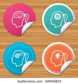 Round stickers or website banners. Head with brain and idea lamp bulb icons. Female woman think symbols. Cogwheel gears signs. Circle badges with bended corner. Vector