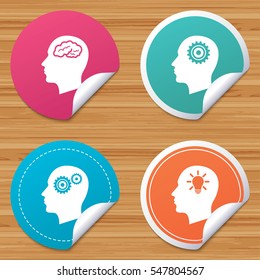 Round stickers or website banners. Head with brain and idea lamp bulb icons. Male human think symbols. Cogwheel gears signs. Circle badges with bended corner. Vector