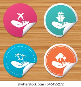 Round stickers or website banners. Helping hands icons. Travel flight or shipping insurance symbol. Palm tree sign. Save nature forest. Circle badges with bended corner. Vector
