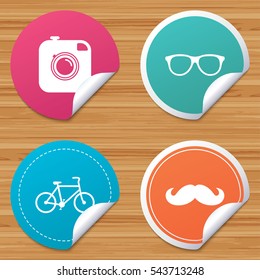 Round stickers or website banners. Hipster photo camera with mustache icon. Glasses symbol. Bicycle family vehicle sign. Circle badges with bended corner. Vector