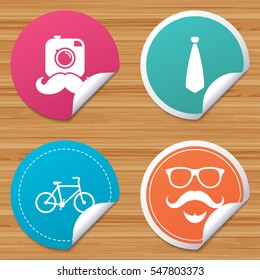 Round stickers or website banners. Hipster photo camera. Mustache with beard icon. Glasses and tie symbols. Bicycle family vehicle sign. Circle badges with bended corner. Vector