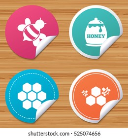 Round stickers or website banners. Honey icon. Honeycomb cells with bees symbol. Sweet natural food signs. Circle badges with bended corner. Vector
