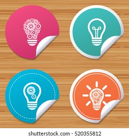 Round stickers or website banners. Light lamp icons. Lamp bulb with cogwheel gear symbols. Idea and success sign. Circle badges with bended corner. Vector