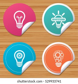 Round stickers or website banners. Light lamp icons. Circles lamp bulb symbols. Energy saving with cogwheel gear. Idea and success sign. Circle badges with bended corner. Vector