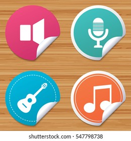 Round stickers or website banners. Musical elements icons. Microphone and Sound speaker symbols. Music note and acoustic guitar signs. Circle badges with bended corner. Vector