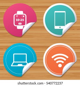 Round stickers or website banners. Notebook and smartphone icons. Smart watch symbol. Wi-fi and battery energy signs. Wireless Network symbol. Mobile devices. Circle badges with bended corner. Vector