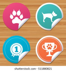 Round stickers or website banners. Pets icons. Cat paw with clutches sign. Winner cup and medal symbol. Dog silhouette. Circle badges with bended corner. Vector
