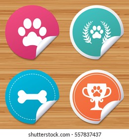 Round stickers or website banners. Pets icons. Dog paw sign. Winner laurel wreath and cup symbol. Pets food. Circle badges with bended corner. Vector