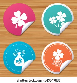 Round stickers or website banners. Saint Patrick day icons. Money bag with clovers and coins sign. Symbol of good luck. Circle badges with bended corner. Vector