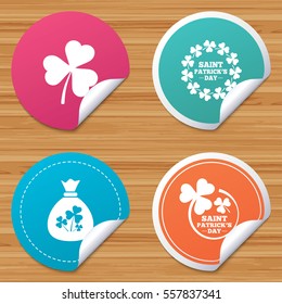 Round stickers or website banners. Saint Patrick day icons. Money bag with clover sign. Wreath of trefoil shamrock clovers. Symbol of good luck. Circle badges with bended corner. Vector