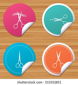 Round stickers or website banners. Scissors icons. Hairdresser or barbershop symbol. Cut dash dotted line. Tailor symbol. Circle badges with bended corner. Vector