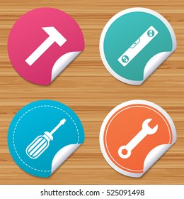Round stickers or website banners. Screwdriver and wrench key tool icons. Bubble level and hammer sign symbols. Circle badges with bended corner. Vector
