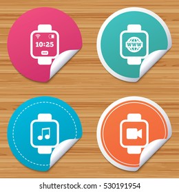 Round stickers or website banners. Smart watch icons. Wrist digital time watch symbols. Music, Video, Globe internet and wi-fi signs. Circle badges with bended corner. Vector