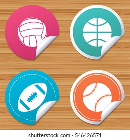 Round stickers or website banners. Sport balls icons. Volleyball, Basketball, Baseball and American football signs. Team sport games. Circle badges with bended corner. Vector