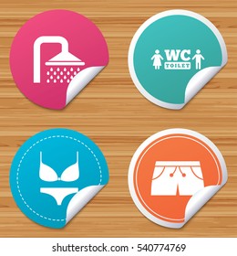 Round stickers or website banners. Swimming pool icons. Shower water drops and swimwear symbols. WC Toilet sign. Trunks and women underwear. Circle badges with bended corner. Vector