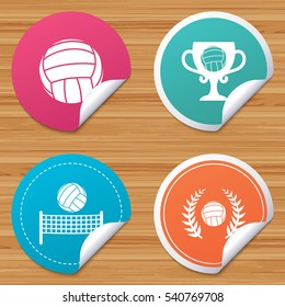Round stickers or website banners. Volleyball and net icons. Winner award cup and laurel wreath symbols. Beach sport symbol. Circle badges with bended corner. Vector